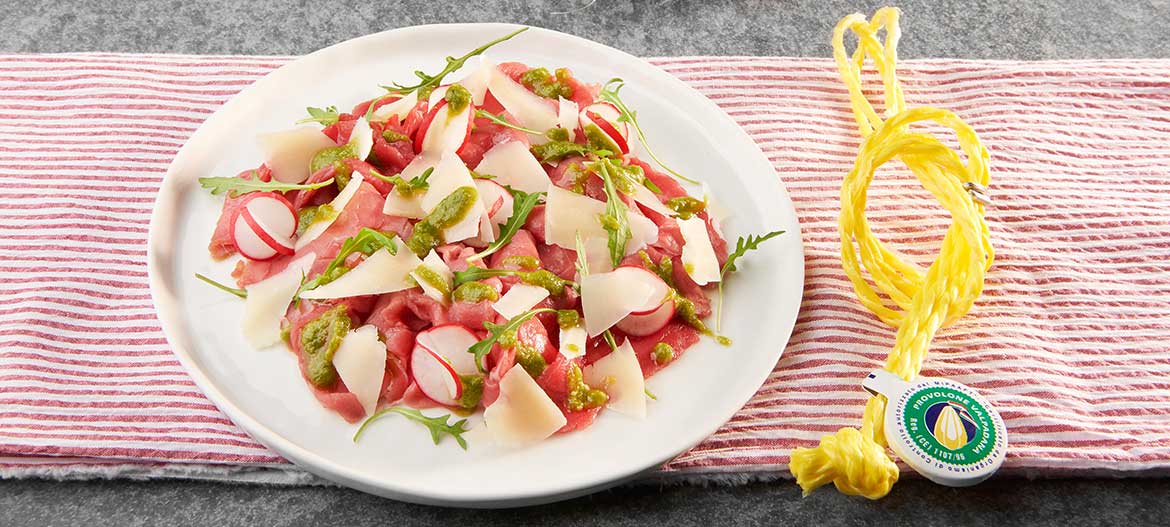 Beef carpaccio with strong Provolone Valpadana P.D.O. and rocket pesto