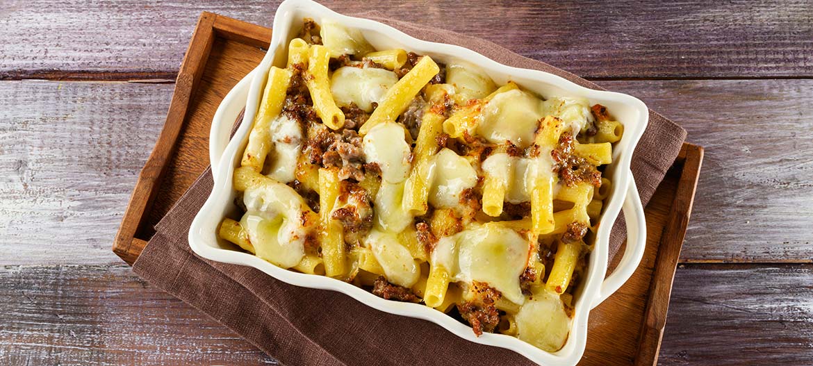 Oven-baked pasta with mild Provolone Valpadana, sausage and rosemary